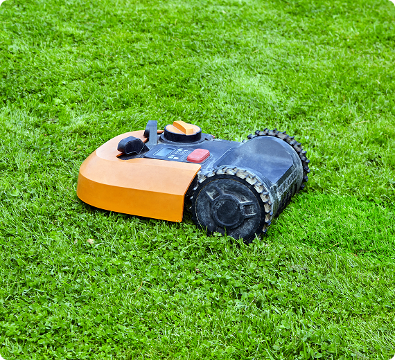 Robotic lawn mower on green grass